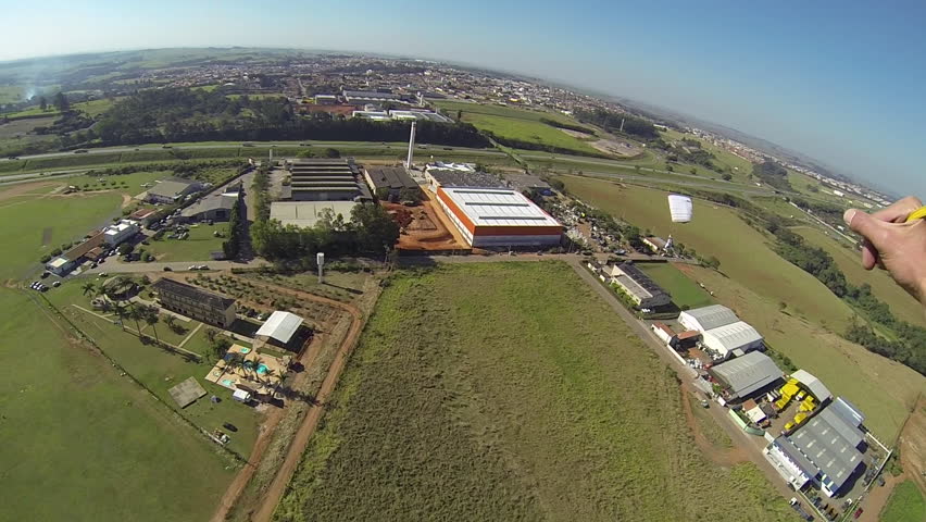 Skydiver landing with parachute canopy at dropzone in Boituva, Brazil.