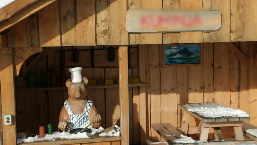 Small wooden house with bear and table at winter location