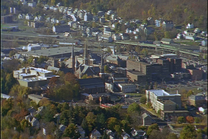 Aerial shot over downtown North Adams zoom out to WS with the Green Mountains behind in North Adams, Massachusetts.