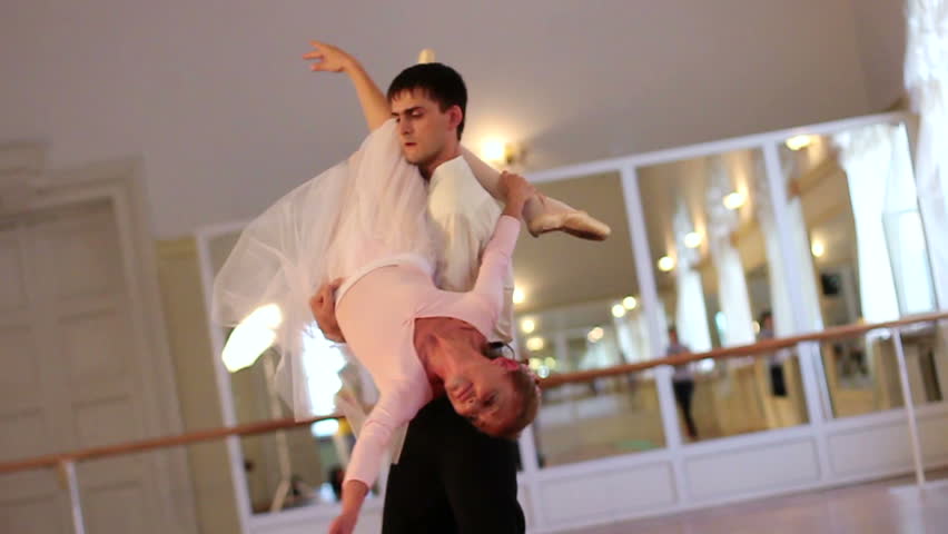Ballet dancing, young male dancer twirling ballerina around