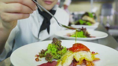 A delicious gourmet meal is being given the finishing touches by the chef in a restaurant or hotel kitchen, ready for service to the customer.