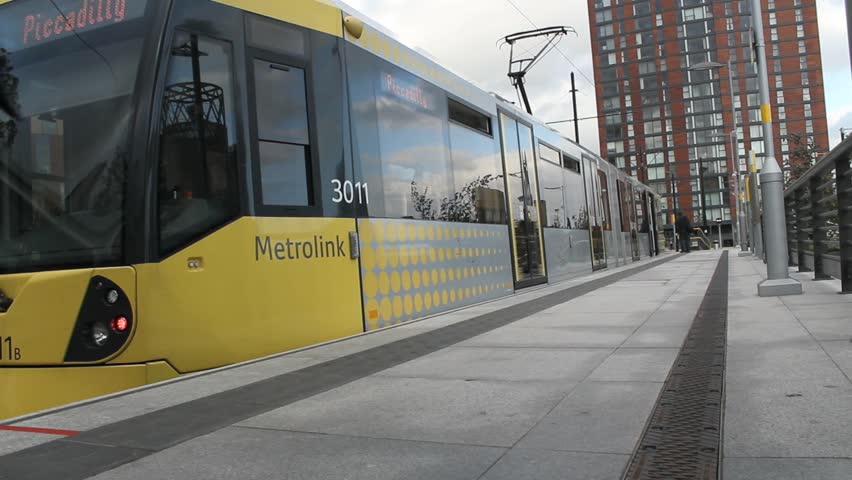 A female walks briskly and enters a tram