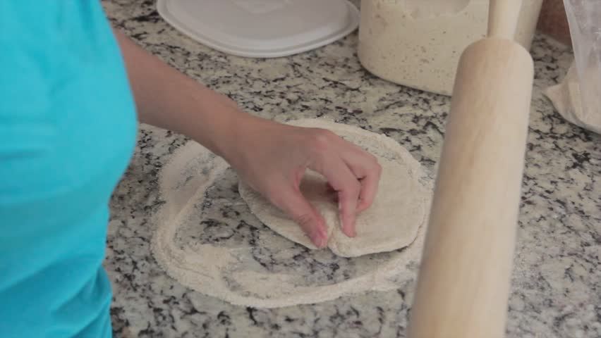 Woman making a pizza dough.