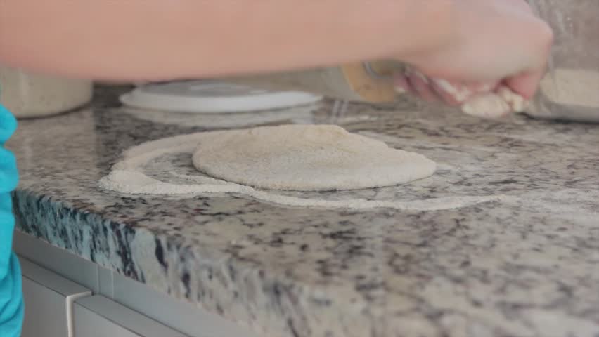 Woman making a pizza dough.