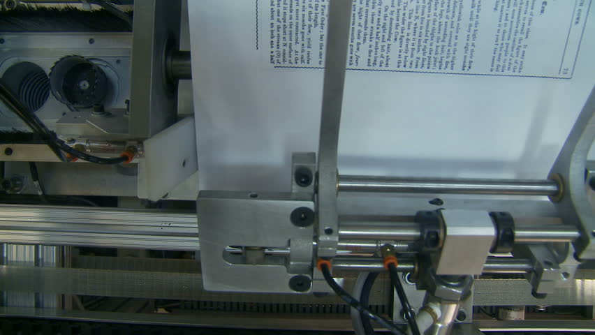 Detail of a book printing machine. (note: book being printed is a public domain