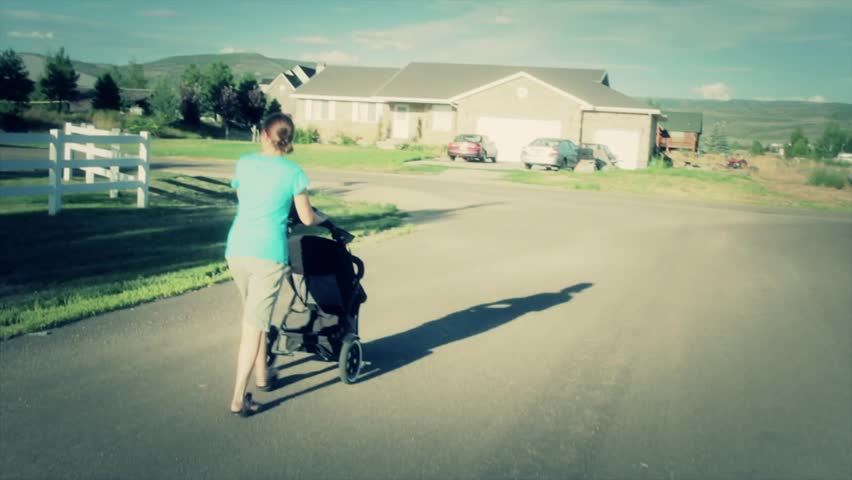 A family walking their baby in a stroller