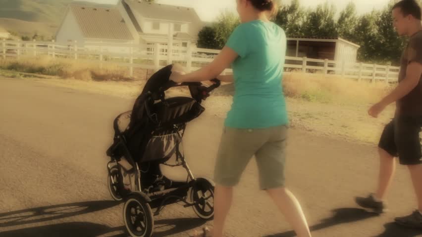A family walking their baby in a stroller
