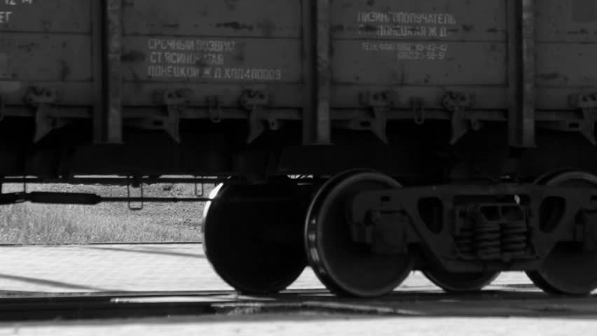 Cargo train wheels close up - transportation concept. Black and white video