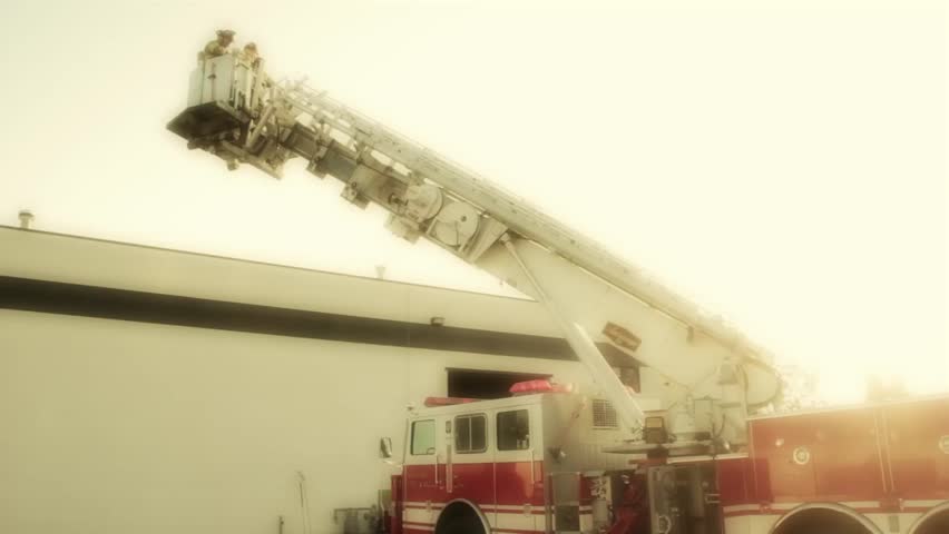 Firemen fighting a fire at a warehouse