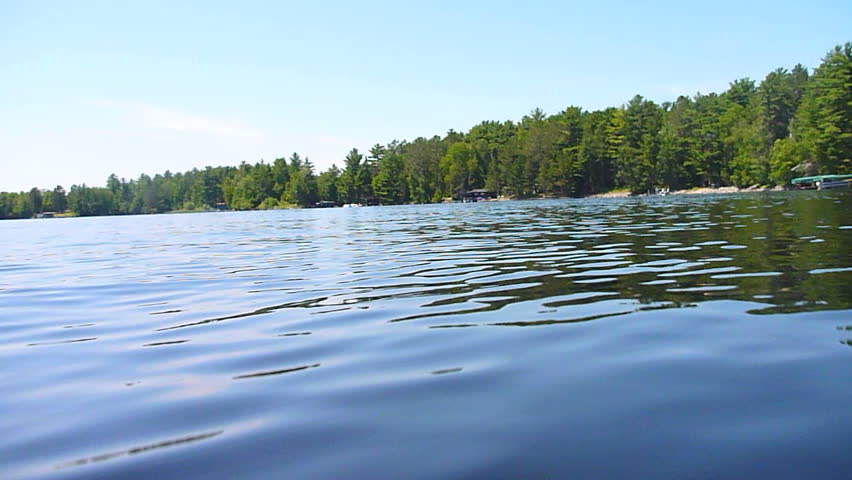 Low angle while boating around Minnesota lake on sunny day.