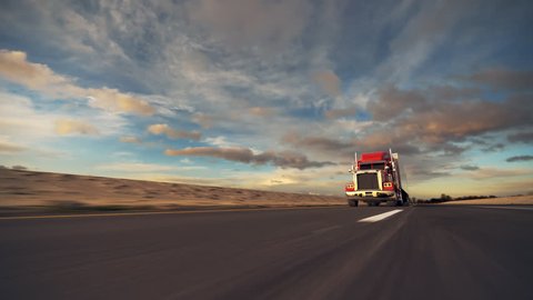 18 Wheel Truck on the road with sunset in the background. Large delivery truck is moving towards setting sun.