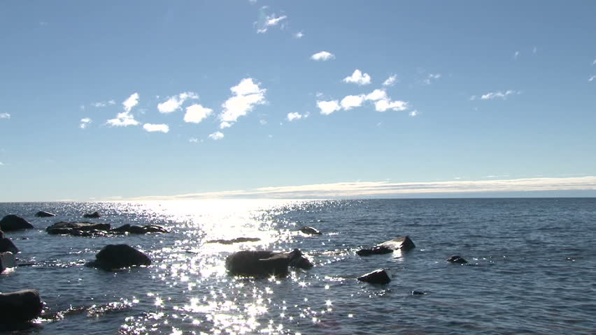 Lake Superior scenic on sunny, blue sky day with gentle shore break.