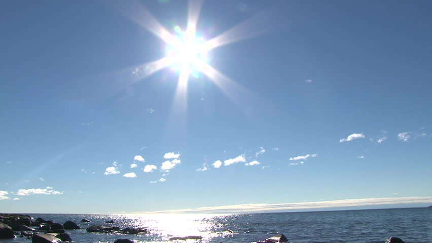 Lake Superior scenic on sunny, blue sky day with gentle shore break, camera tilt