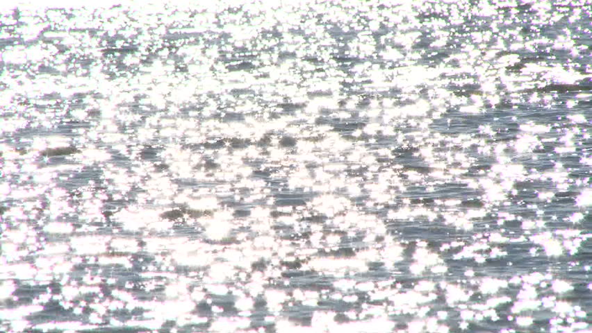 Shimmering water on sunny day, slow motion.