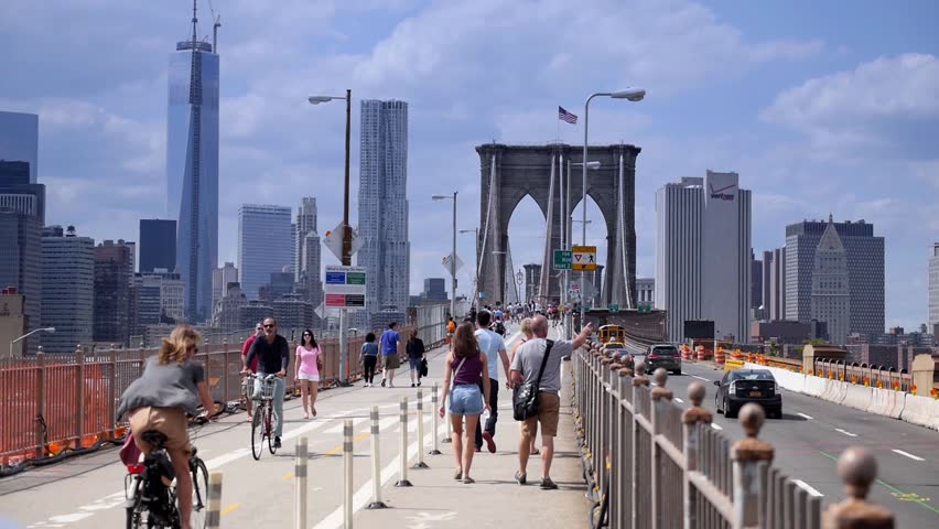 NEW YORK CITY, Circa August, 2013 - Pedestrians walk over the Brooklyn Bridge.