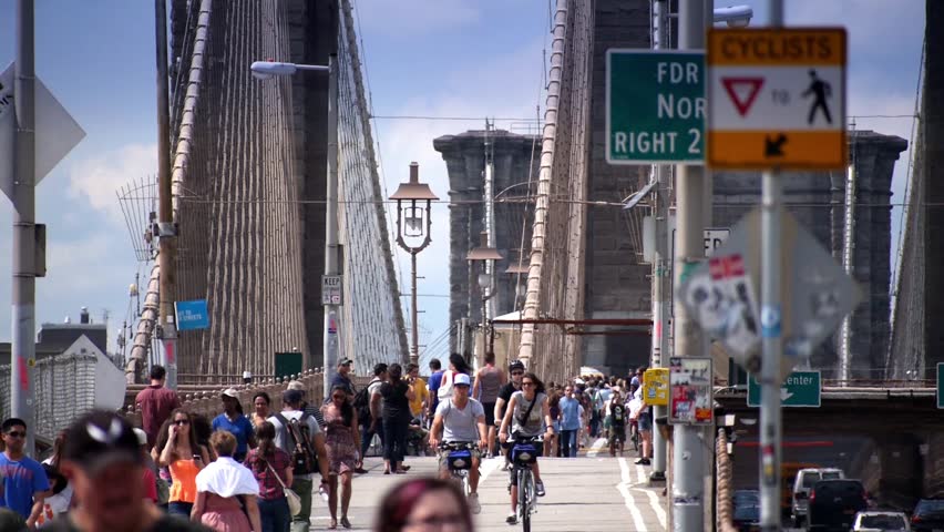 NEW YORK CITY, Circa August, 2013 - Pedestrians walk over the Brooklyn Bridge. 