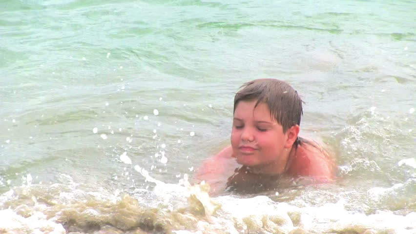 boy swimming in tropical sea