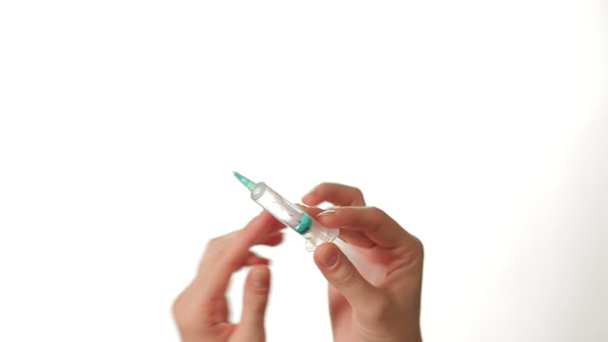 Hands Preparing Syringe