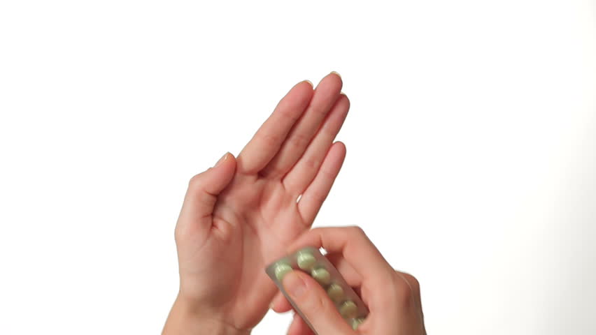 Hands Pressing Pill out of Blister Package on white background