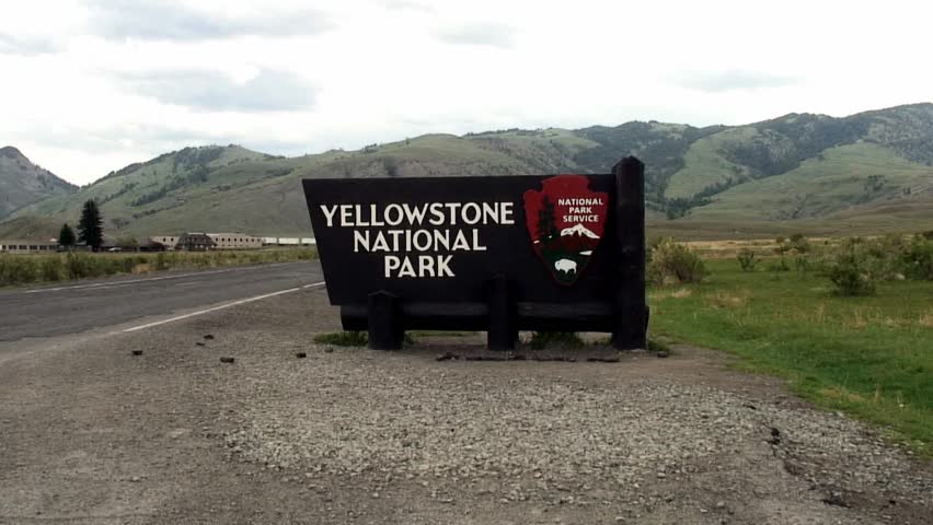 medium shot of Yellowstone National Park entrance sign.