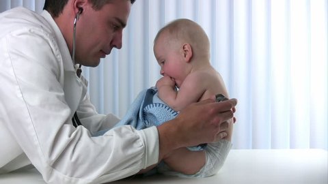 Male doctor listens to a babyÃ¢??s lungs using a stethoscope