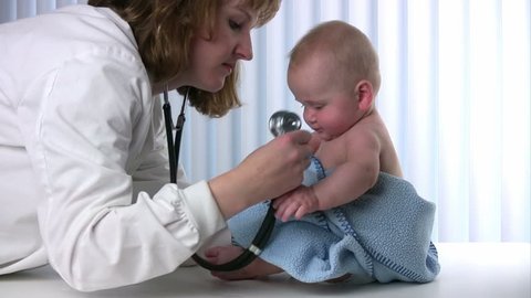 Female doctor listens to a babyÃ¢??s lungs using a stethoscope