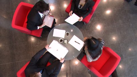 Business meeting over coffee in large financial building. High quality HD video footage