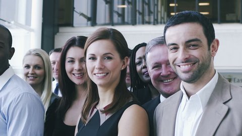 Portrait of young diverse business team. Large business organization in corporate building.