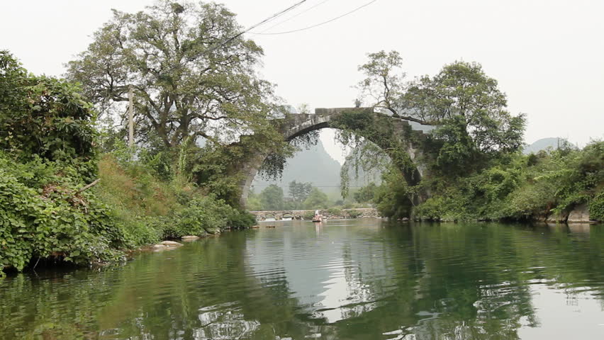Beautiful Yulong river with ancient stone arch bridge. - Yangshuo Guilin,