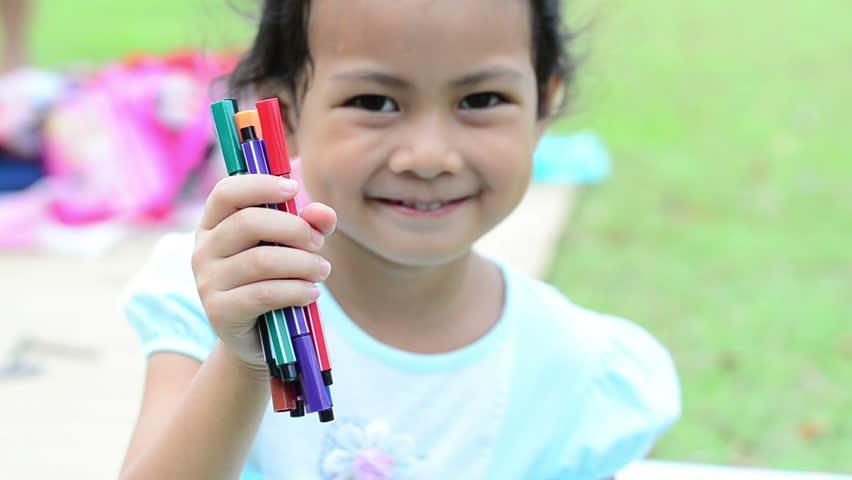 Going back to school : girl holding color pens