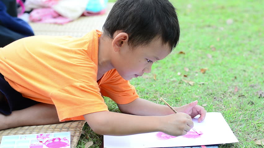 Going back to school : Boy  painting over green grass