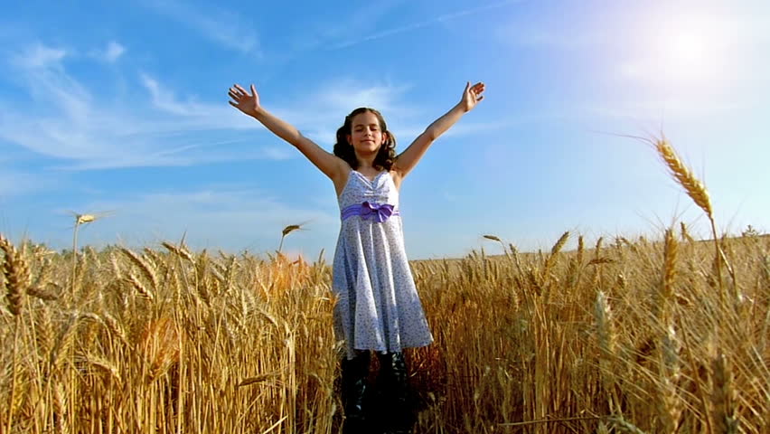 Little girl running cross the wheat field at sunset.Slow motion,high speed camera