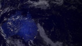 Telecommunication satellite over earth Australia night space view.. Cinema quality animation. Focus changes from earth to satellite. Telecommunication satellite orbiting the Earth. NASA PD image used.