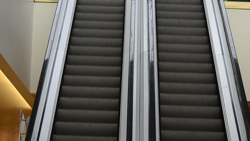 Shopping Mall Escalator seamless loop HD. Video of empty escalators in a busy