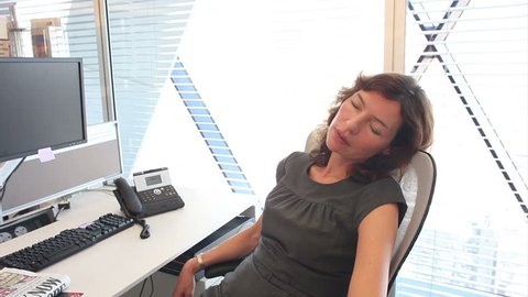 Funny scene wityh sleeping office workers. Natural and realistic office setting with relaxed team - too relaxed!