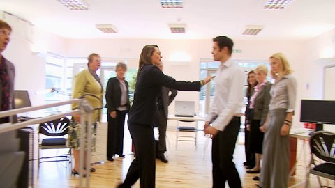 Office Fight - angry office workers come to blows at work. High quality HD video footage