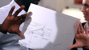 Architects or engineers in creative office looking at design plans. High quality HD video footage