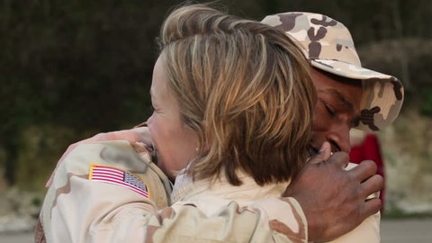 Army soldier returning home to the embrace of his wife
