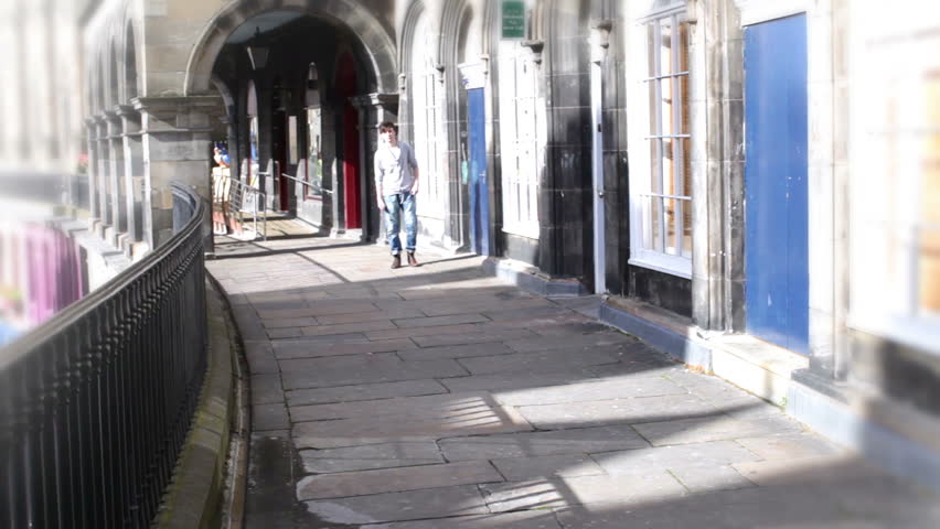 Friends talking out and about in the city. Teenagers spot a good looking boy.