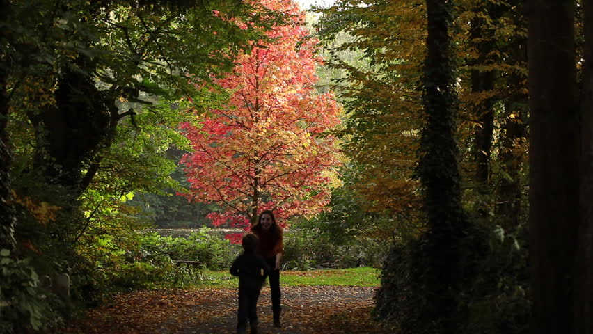 son hugging mum in a park, autumn