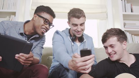 Young men having fun with phone and technology