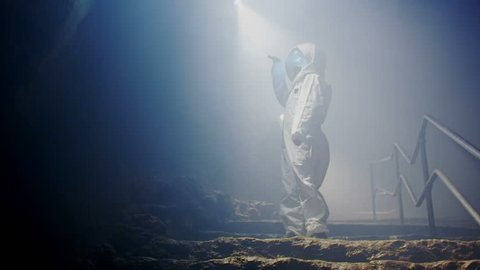 Space science fiction. An Astronaut (or Alien) in dark cave structure. A fantasy science fiction film of epic proportions.