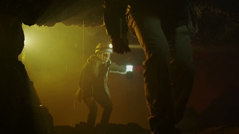 Scientists and miners exploring dark caves. Geologists, explorers, adventurers, pot holing, historians or mining company.