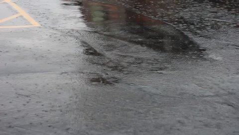 Rain water rushing to a storm drain. 