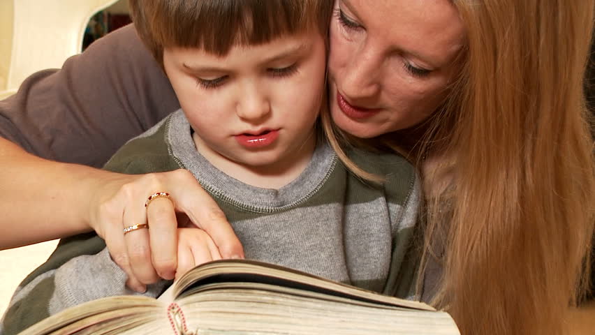 Mother and her son reading a book 