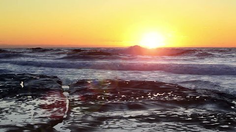 California Southwest Pacific Coast Beach With Waves Crashing Sea Shore Waves On Coastal Rocks And Beautiful Setting Sun Golden Orange Sunset With Lens Flare Captured at 1920x1080p HD ~ Text Copy space