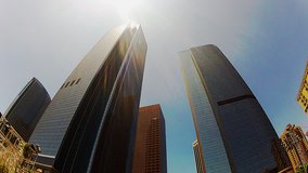 Low angle shot of high rise skyscraper office buildings. This clip features a clip that conveys business, commerce and success. Corporate power, the power of corporations, the almighty dollar. 