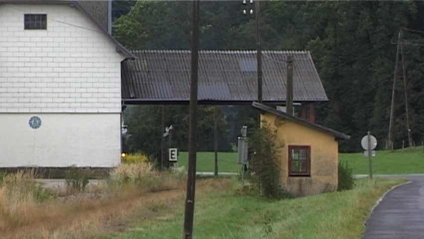 Steam train with historic steam locomotive passing in scenic landscape