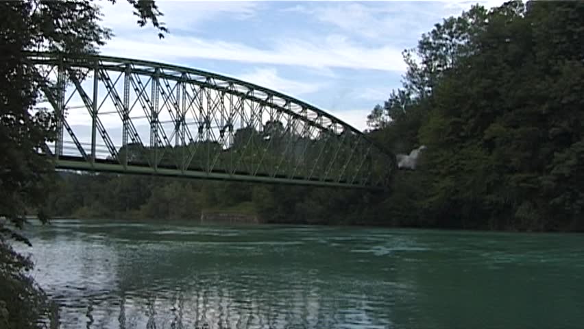 Steam train with historic steam locomotive passing in scenic landscape