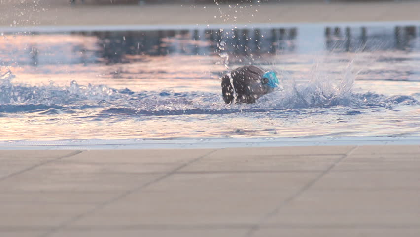 Slow Motion Shot Of A Little Girl Swimming In Swimming Pool Water